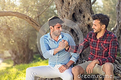 Happy gay couple in park Stock Photo
