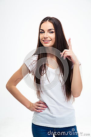 Happy young girl pointing finger up Stock Photo