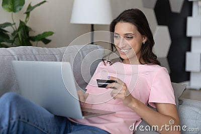 Happy young indian arab woman shopping online using credit card. Stock Photo