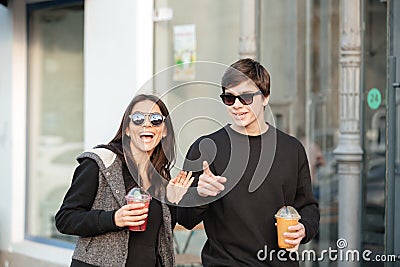 Happy young lady walking outdoors with her brother Stock Photo