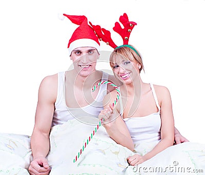 Happy young loving couple in bed on Xmas morning Stock Photo