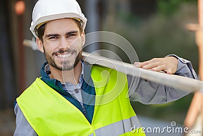 happy young man carrying lumber Stock Photo