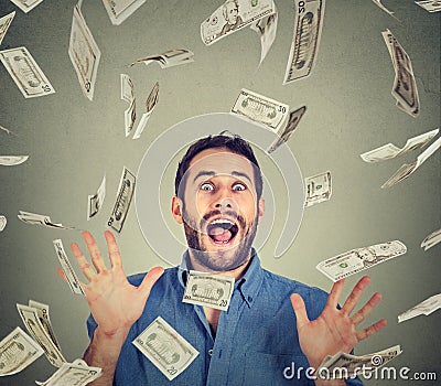 Happy young man going crazy screaming super excited under money rain Stock Photo