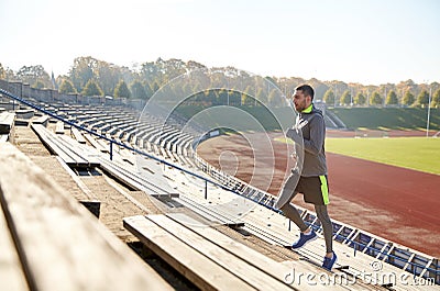 Happy young man running upstairs on stadium Stock Photo