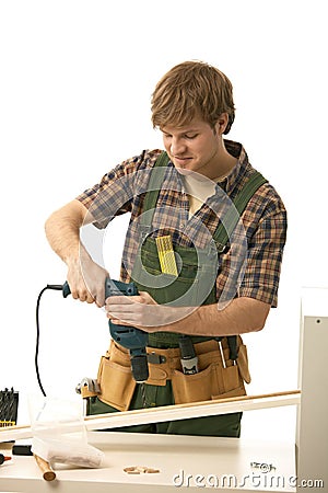 Happy young man tinkering Stock Photo