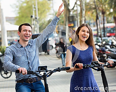 Happy young man and woman with electrkc bikes Stock Photo