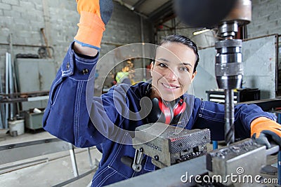 happy young mechanic apprentice working on milling machine Stock Photo
