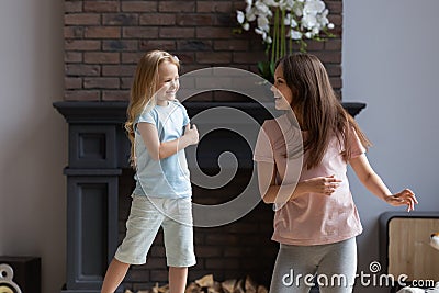 Happy young mother dance relax with small daughter Stock Photo