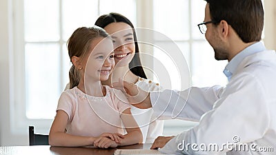 Smiling family of two visiting doctor therapist for checkup. Stock Photo