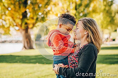 Happy young mother holding sweet toddler boy Stock Photo