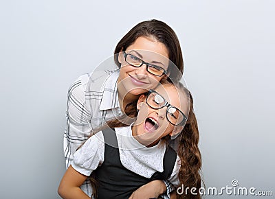 Happy young mother and lauging kid in fashion glasses hugging on empty copy space Stock Photo