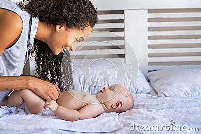 Mother changing baby diaper Stock Photo