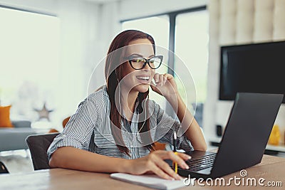 Happy young nerd university student laughing at laptop Stock Photo