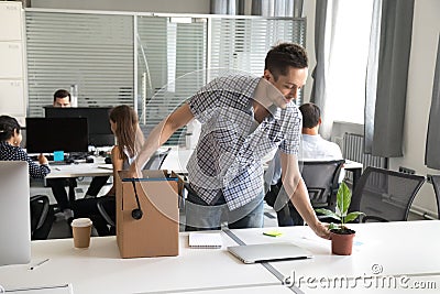 Happy young office worker, intern unpack belongings at workplace Stock Photo