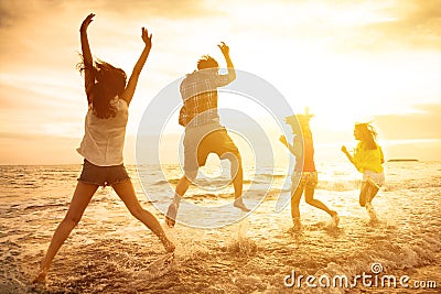 happy young people dancing on the beach Stock Photo