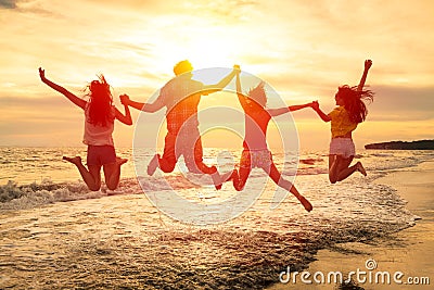 happy young people jumping on the beach Stock Photo