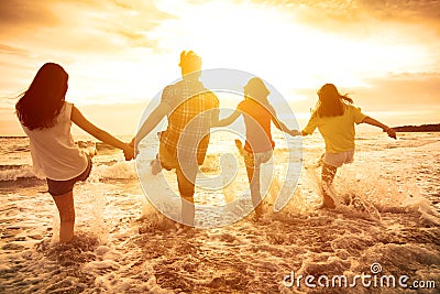 happy young people playing on the beach Stock Photo