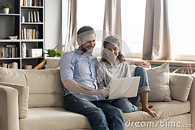 Happy young romantic bonding couple watching online movie on computer. Stock Photo