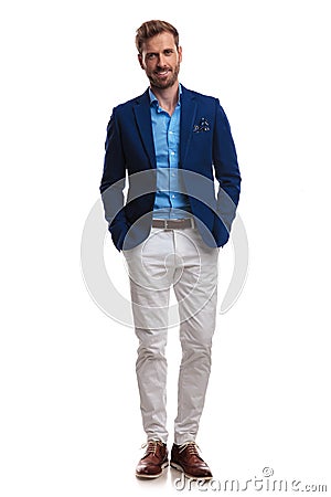 Happy young smart casual man standing with hands in pockets Stock Photo