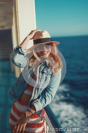 Happy traveler woman in hat toothy smile on cruise ship Stock Photo