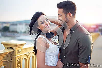 Happy young trendy urban couple smile on bridge Stock Photo
