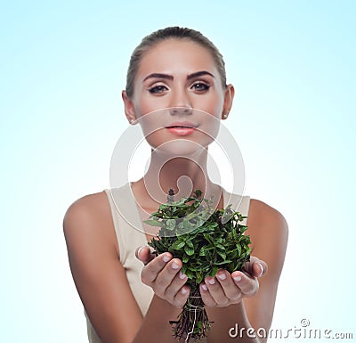 Happy young woman with a bundle of fresh mint. Concept vegetarian dieting - healthy food Stock Photo