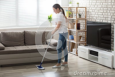 Young Woman Cleaning The Hardwood Floor Stock Photo