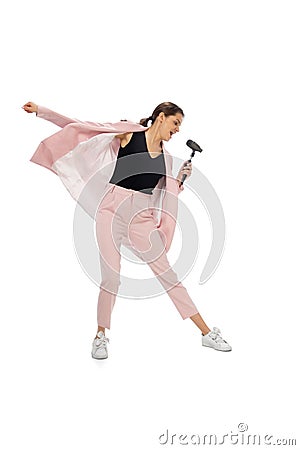 Happy young woman dancing in stylish clothes or suit, remaking legendary moves of celebrity from culture history Stock Photo