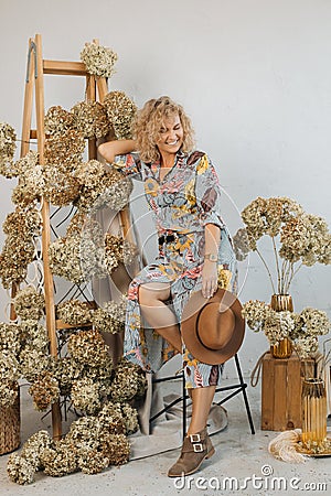 Happy young woman decorator with hat, standing smiling and glowing with happiness. Concept of successful work and doing what you Stock Photo