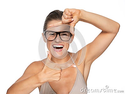 Happy young woman in eyeglasses framing with hands Stock Photo