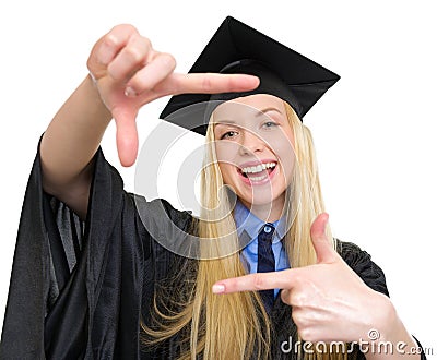 Happy woman in graduation gown framing with hands Stock Photo