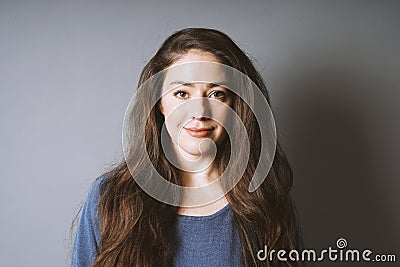 Happy young woman in her 20s with long brunette hair Stock Photo