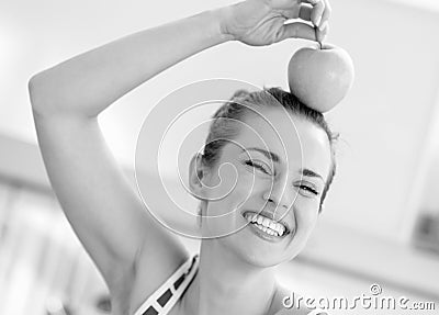 Young woman holding apple on head Stock Photo