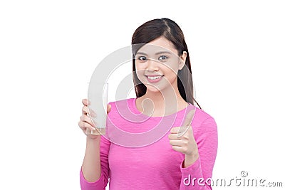Happy young woman holding a glass with milk and showing thumbs u Stock Photo