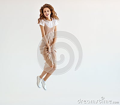 Happy young woman jumping on white background Stock Photo