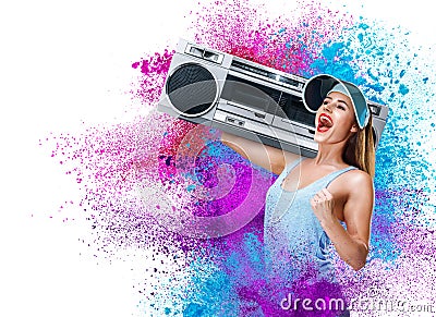 Happy young woman listening music with boombox Stock Photo