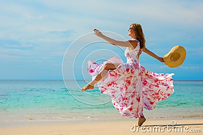 Happy woman making a big step forward on the beach Stock Photo