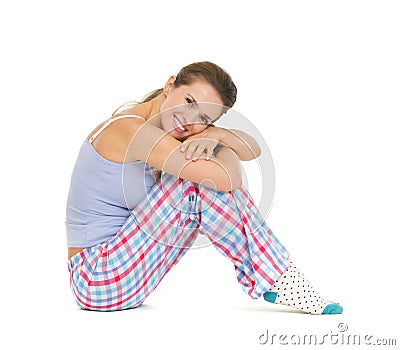 Happy young woman in pajamas sitting on floor Stock Photo