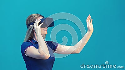 Happy young woman playing on VR glasses indoor. Virtual reality concept with young girl having fun with headset goggles Stock Photo