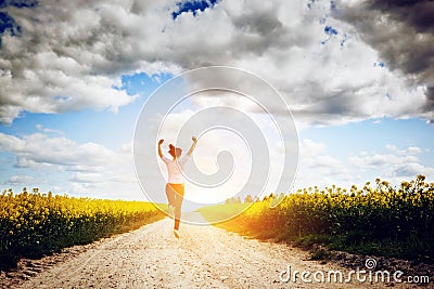 Happy young woman running and jumping for joy Stock Photo