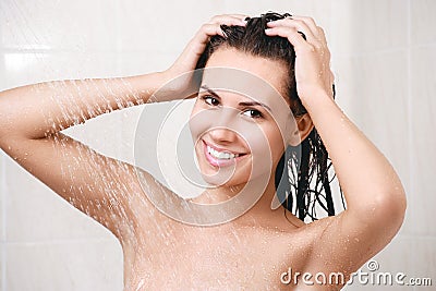 Happy young woman in shower Stock Photo
