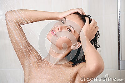 Happy young woman in shower Stock Photo