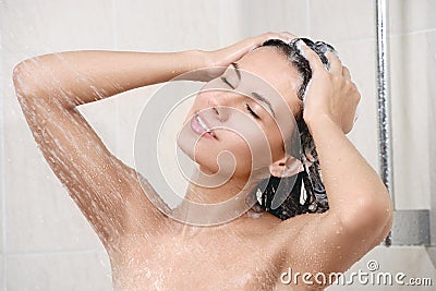 Happy young woman in shower Stock Photo