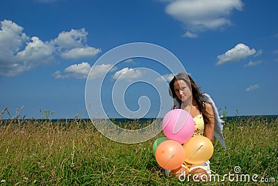 Happy young woman siting with colorful balloons Stock Photo
