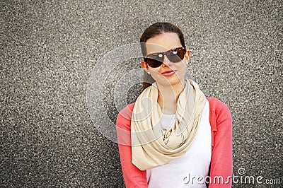 happy young woman is smiling with a blank wall outside with glasses Stock Photo