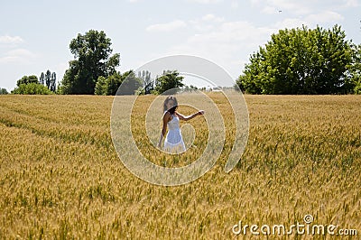 Happy young woman on the sunset or sunrise in summer nature. wedding highlights, portrait in field. cheerful young woman on field Stock Photo