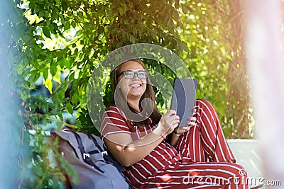 Young woman with tablet computer in the park Stock Photo