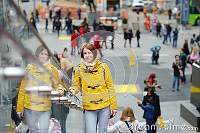 Happy young woman tourist sightseeing at Times Square in New York City. Female traveler enjoying view of downtown Manhattan. Stock Photo