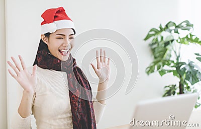 Happy young woman using laptop in video call and celebrating christmas hoilday Stock Photo