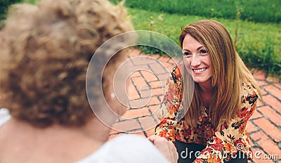 Woman caring elderly woman in a wheelchair Stock Photo